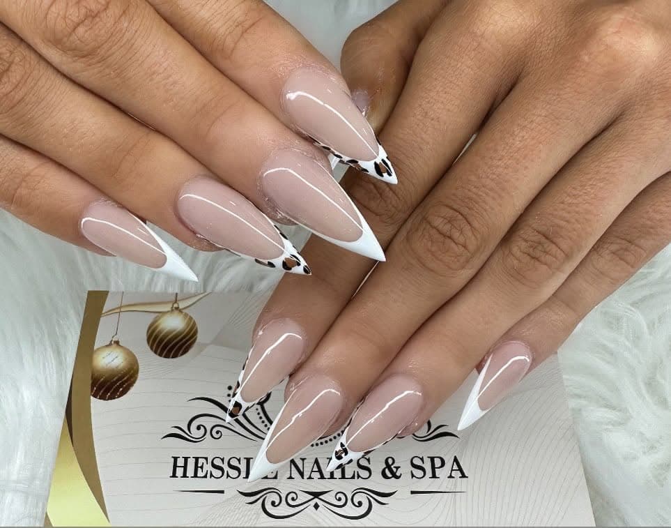Nude stiletto nails with white French tips and leopard print accent